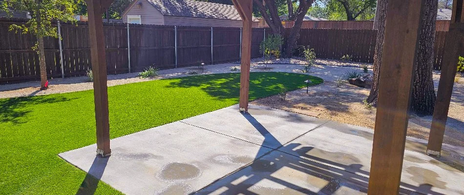 Concrete patio in Lubbock, TX, beside artificial turf.