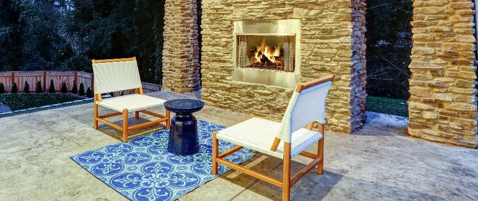 Lounge chairs in front of an outdoor fireplace in Lubbock, TX.