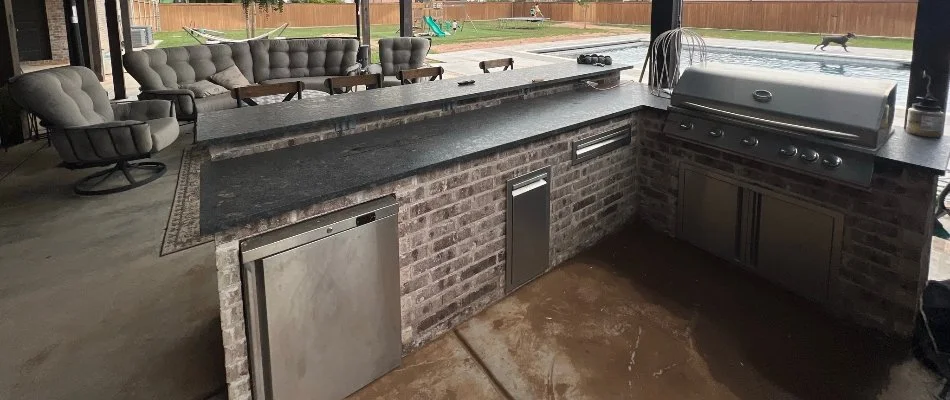 Outdoor kitchen in Lubbock, TX, with stainless steel appliances.