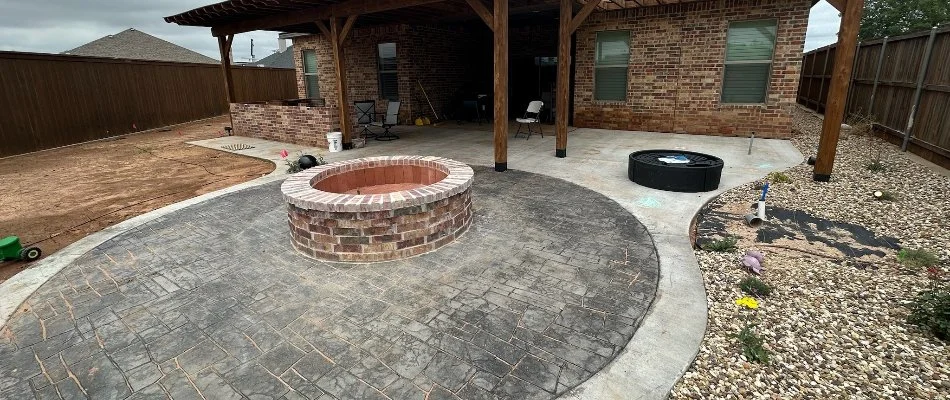 Patio in Lubbock, TX, with a brick fire pit.