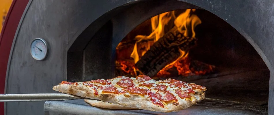 Pizza being put in a pizza oven in Lubbock, TX.