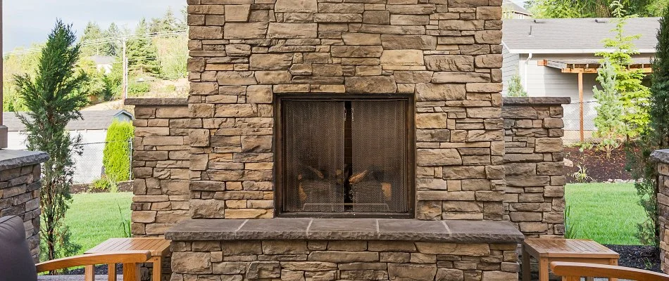 Plants beside an outdoor fireplace in Lubbock, TX.