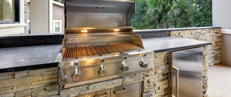 Stainless steel grill in a stone outdoor kitchen in Lubbock, TX.