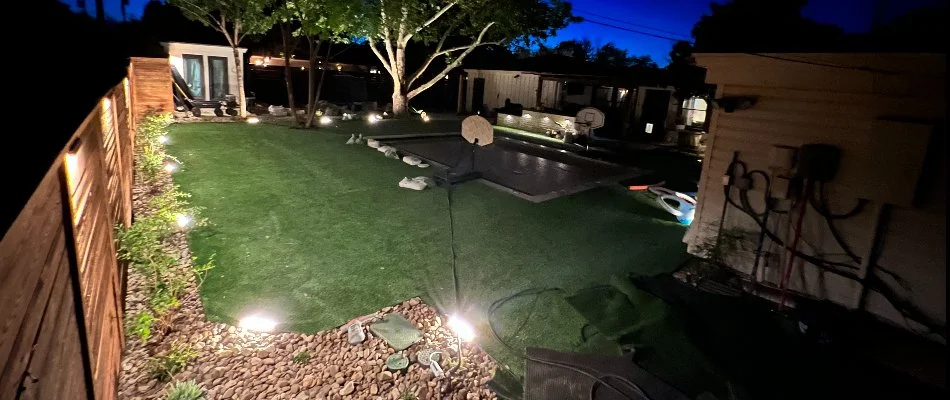 Backyard in Lubbock, TX with landscape lighting installed.