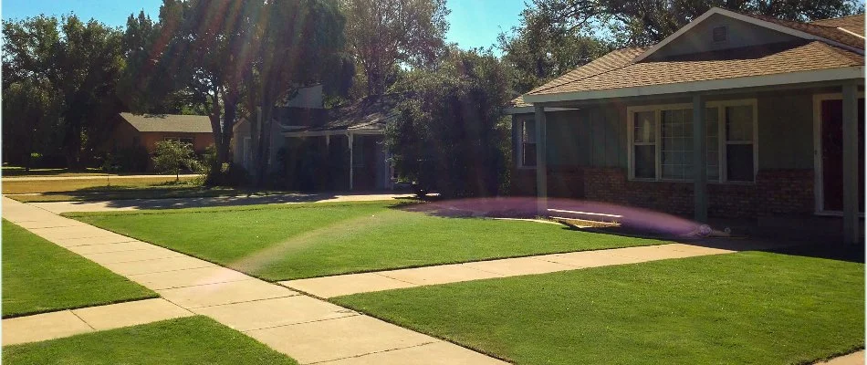 House in Brownfield, TX, with healthy green grass.