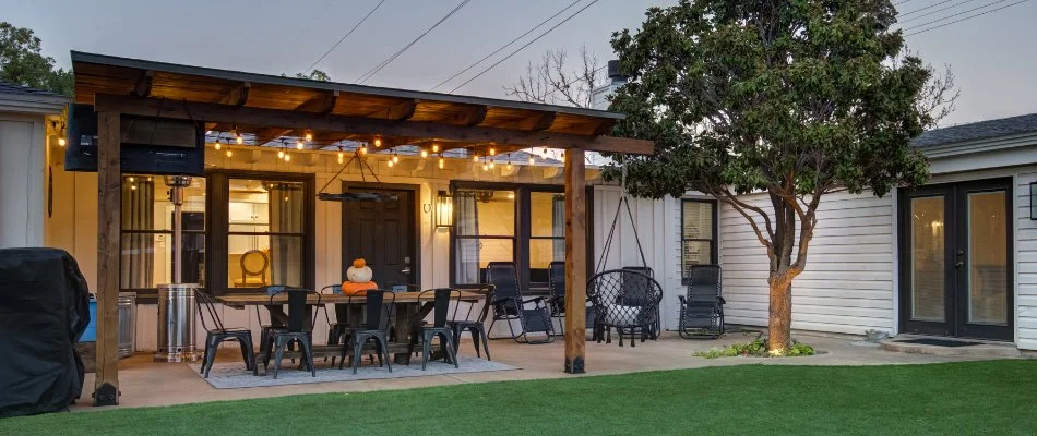 Patio in Seminole, TX, with pergola, tree, and outdoor lighting.