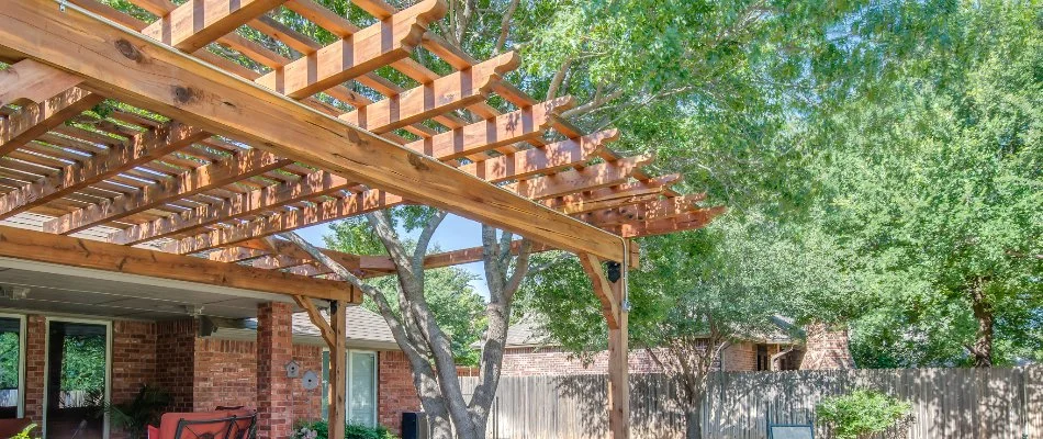 A wooden pergola on a property in Lubbock, TX.